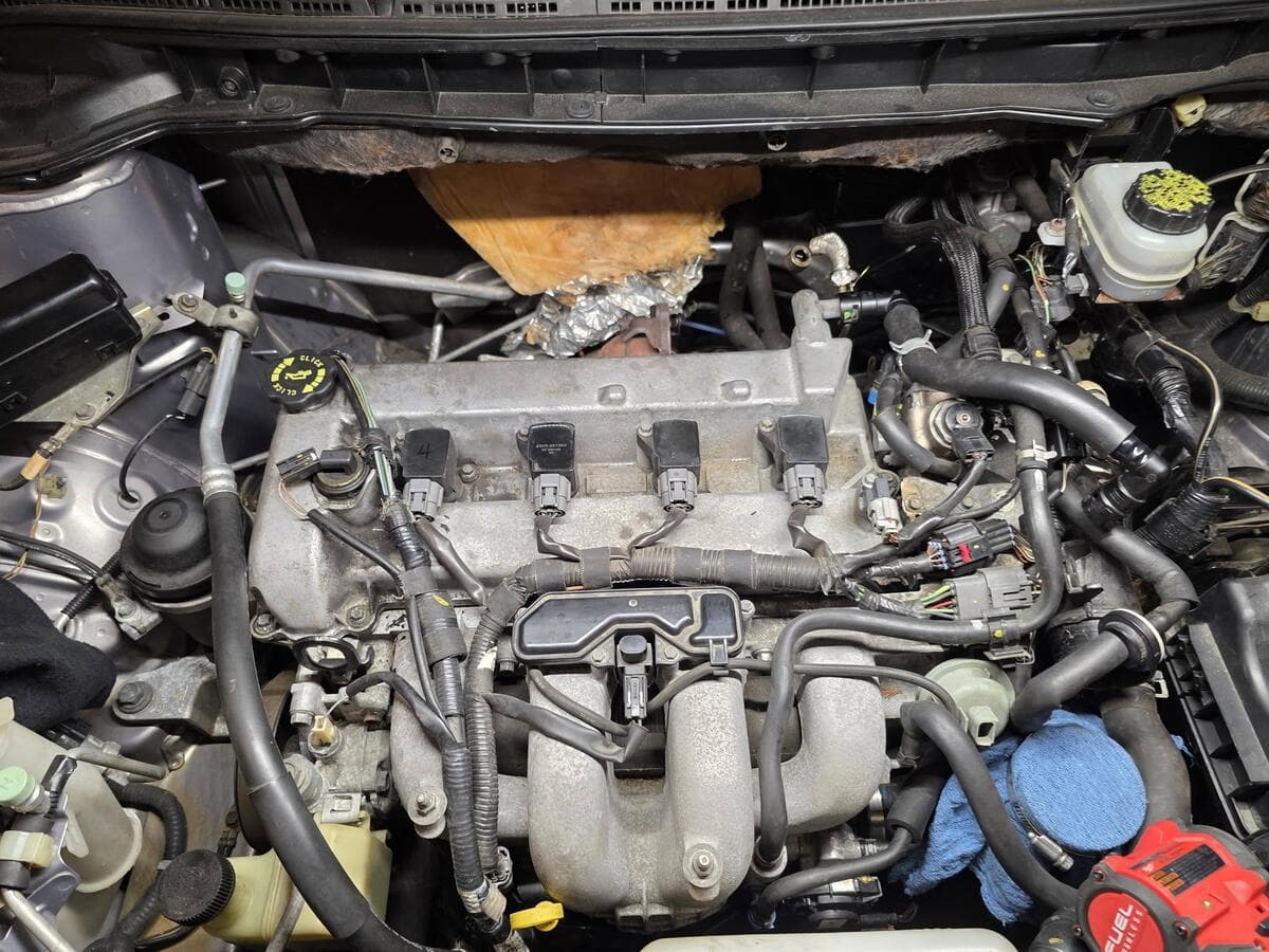 Four-cylinder engine with the ignition coils and intake in view